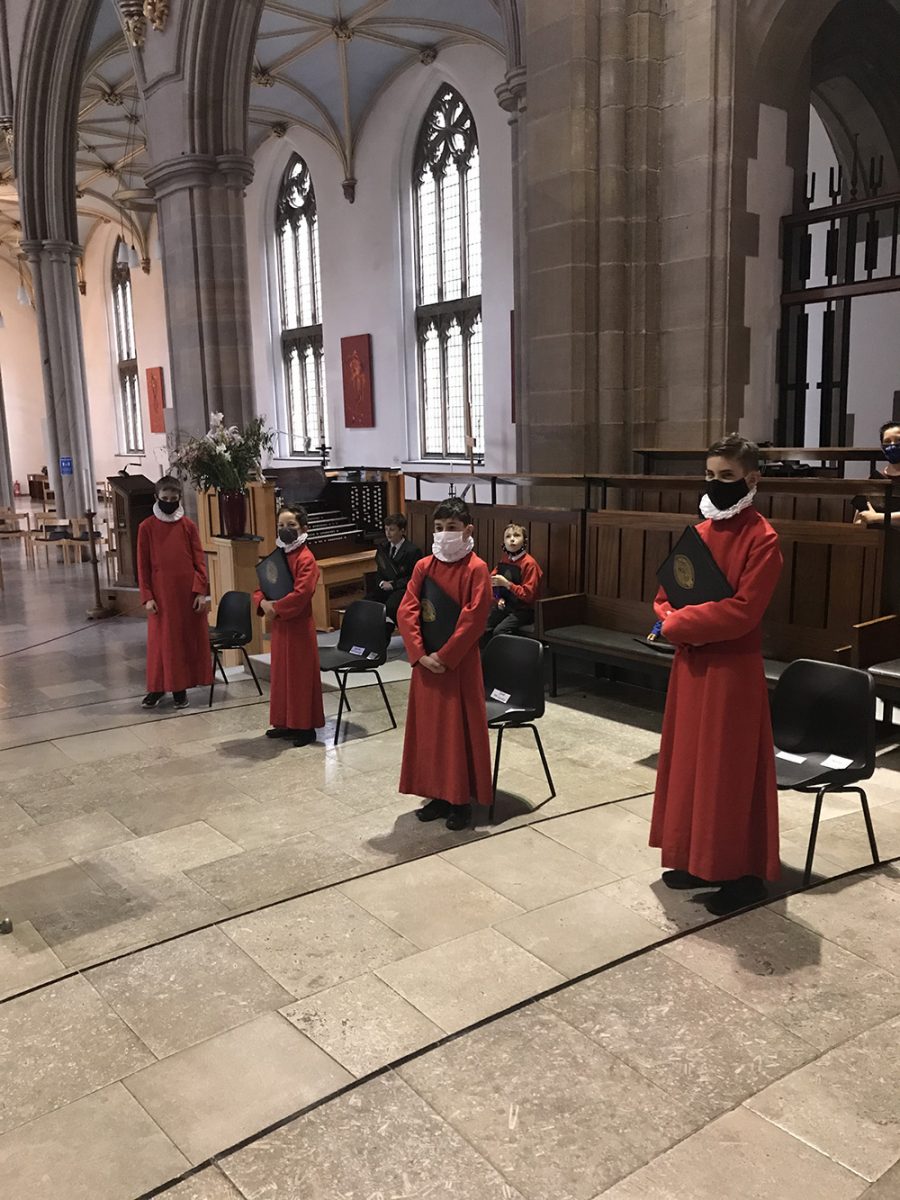 Choirists at Blackburn Cathedral during COVID 19, wearing facemasks